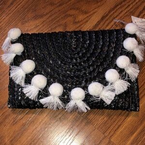 BRAND NEW WOMAN POM POM BLACK AND WHITE CLUTCH. NEW WITH TAGS ON IT.
